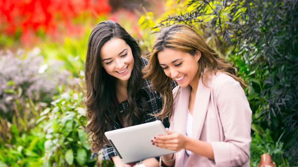 Two women check out a document