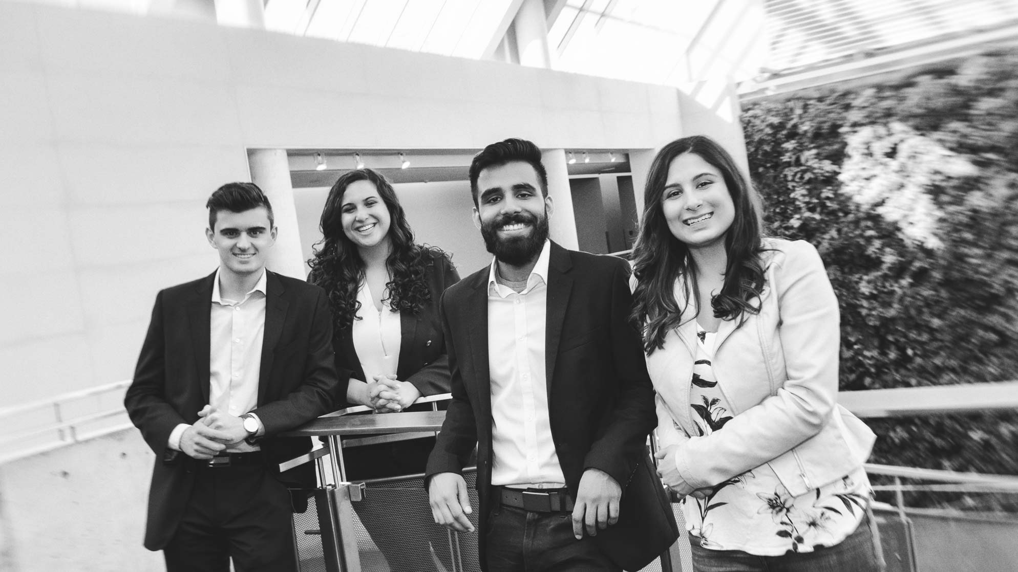 Conor Kelly, Cristina Morrone, Pankush Jhamat and Emma Lal pose for a photo on campus