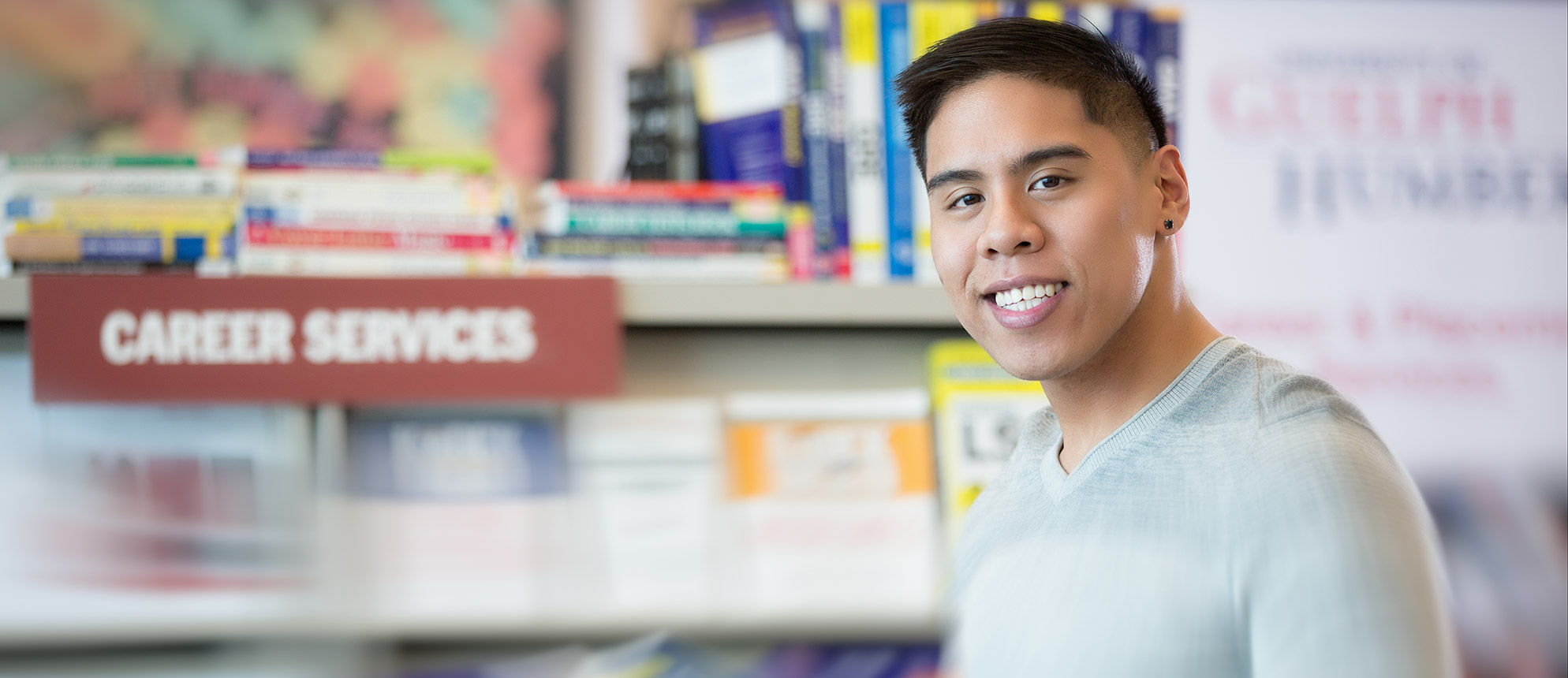 Career Services: a male student stands in the Career Services office