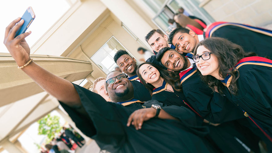 A group of grads pose for a selfie