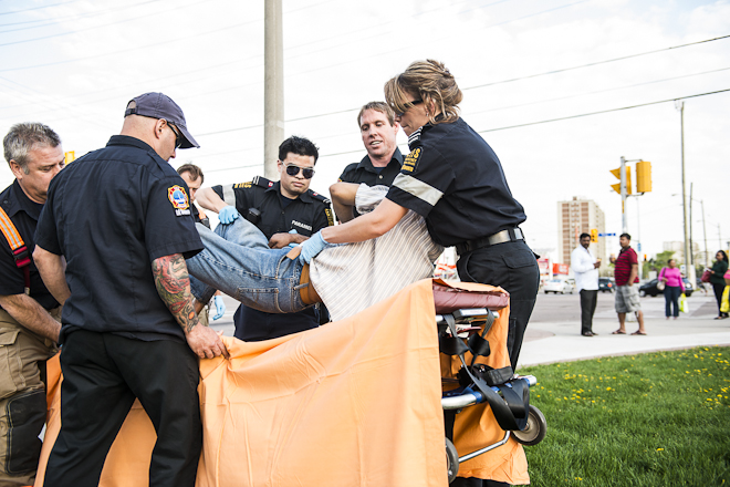 Paramedics lift patient onto table