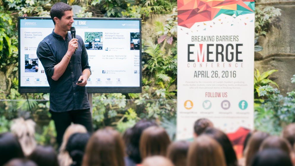 Ben Nemtin – Keynote Speaker – giving speech on stage with seated crowd in foreground_