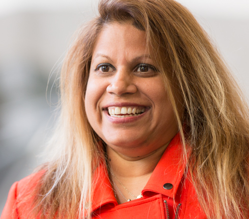 Portrait of Nadia Ghanny wearing an orange jacket