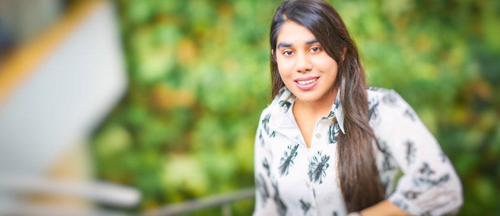 Rakhee Kakkar stands on UofGH staircase.