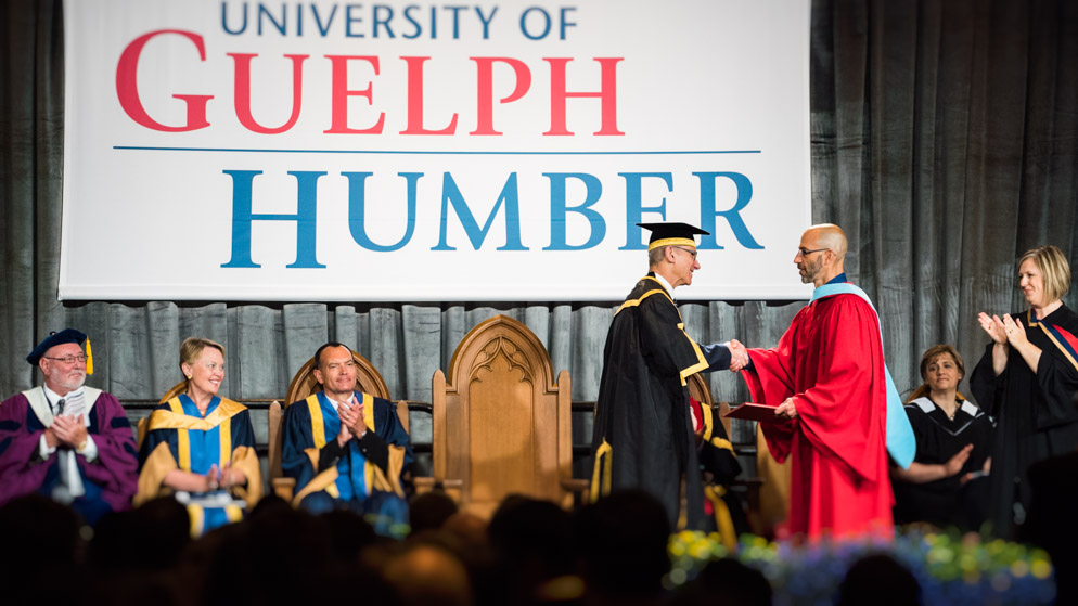 Stephane Grenier shakes hands with U of G Chancellor David Mirvish