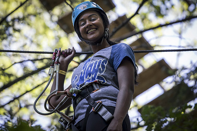 A woman in a Blue Jays T-shirt smiles