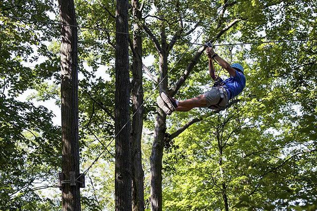 A far shot of an alum ziplining