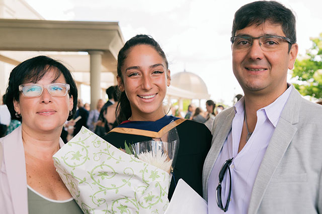 Proud parents pose with their graduate