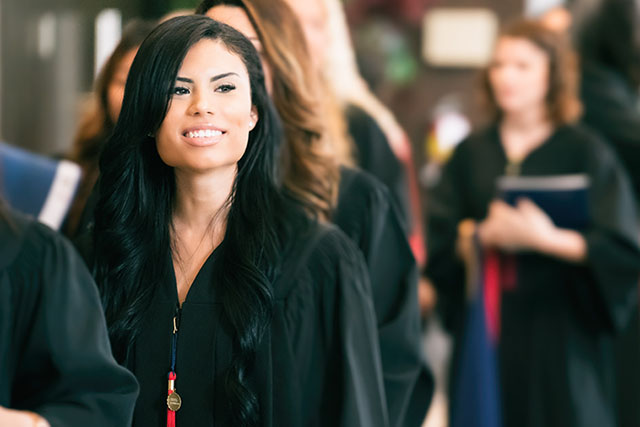 A graduate waits to receive her degree