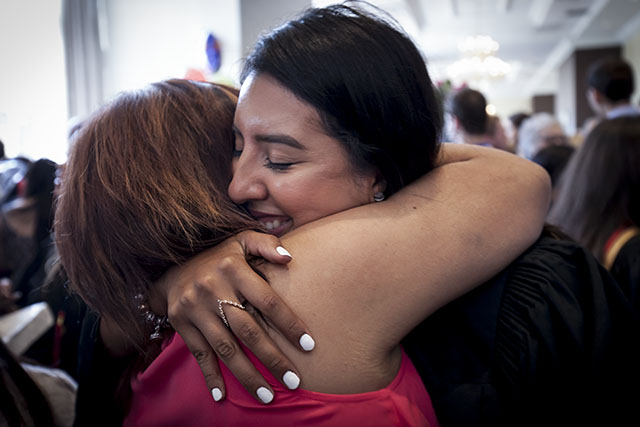 Two graduates hug