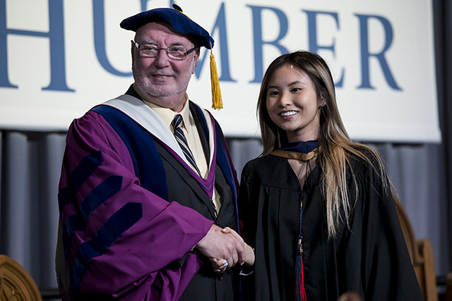 Vice-Provost John Walsh shakes a graduate's hand